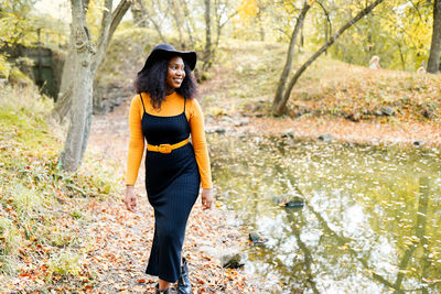 Young woman looking away in forest