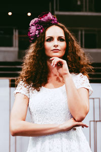 Portrait of a beautiful young woman standing outdoors