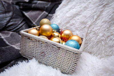 Close-up of baubles in basket on rug