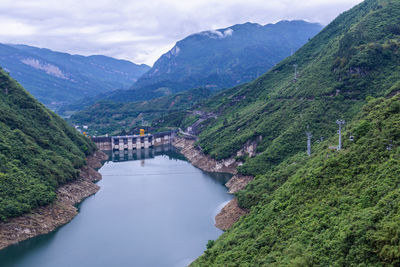 Scenic view of river amidst mountains against sky