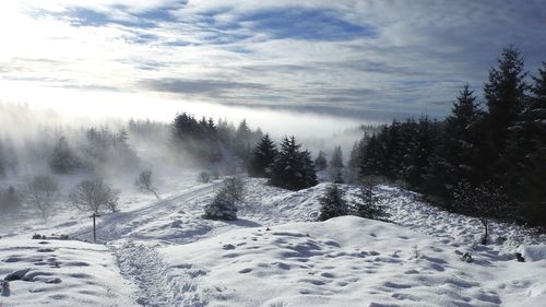 Scenic view of snow covered landscape against sky