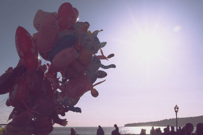 Low angle view of statue against sea at sunset