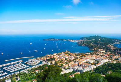 High angle view of townscape by sea against sky