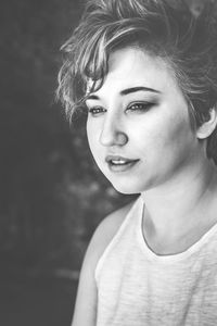 Close-up of young woman with short hair standing outdoors