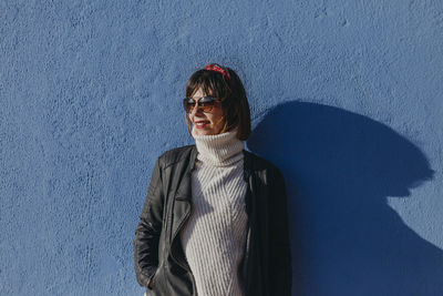 Woman standing against wall