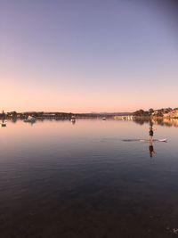 Scenic view of lake against sky at sunset