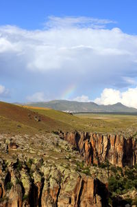 The view on the valley in the mountains with a cart on the foreground.