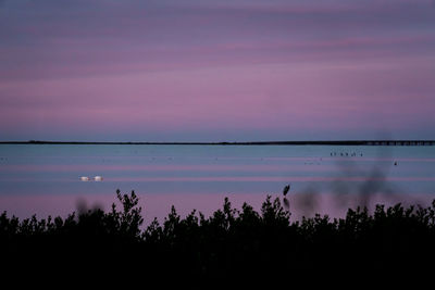 Scenic view of lake against sky at sunset