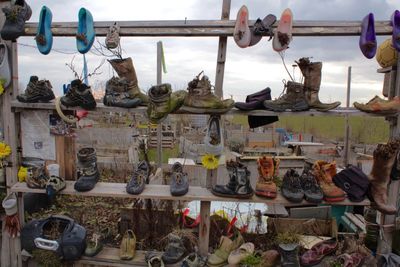 High angle view of old shoes on rack at field