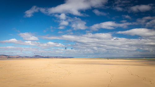 Scenic view of beach against blue sky