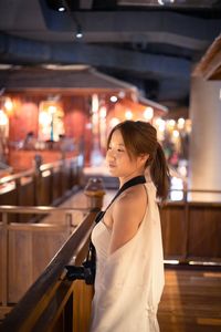 Portrait of young woman standing in cafe