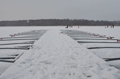 People on pier at sea