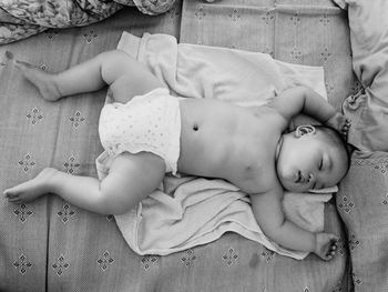 Close-up of baby sleeping in bed