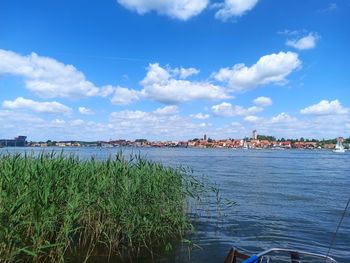 Panoramic view of sea and buildings against sky