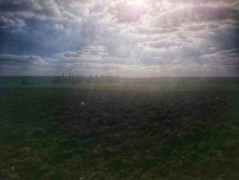 Scenic view of landscape against cloudy sky