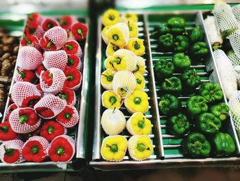High angle view of bell peppers at market stall for sale