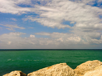 Scenic view of sea against cloudy sky