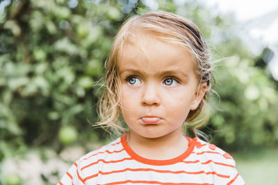 Close-up of cute girl looking away