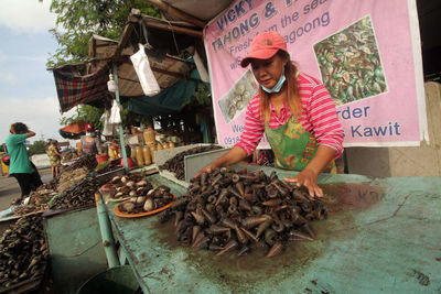 People for sale at market stall