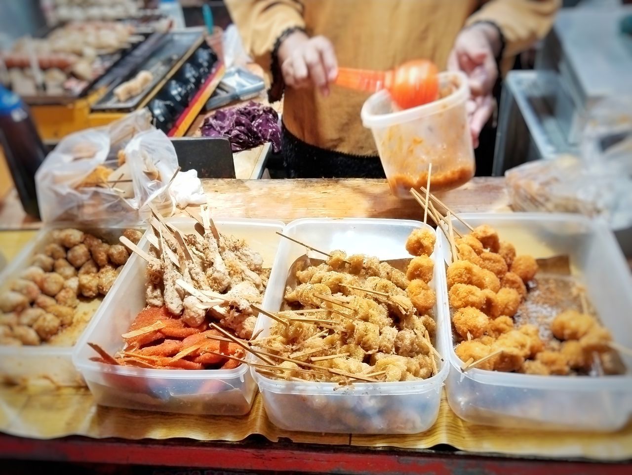 food and drink, food, fast food, freshness, meal, business, market, brunch, market stall, dish, retail, variation, business finance and industry, abundance, breakfast, hand, adult, concession stand, street food, container, small business, one person, snack, healthy eating, indoors, selective focus, lunch, midsection, for sale, selling