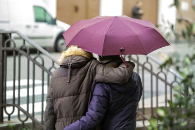 Rear view of woman with umbrella