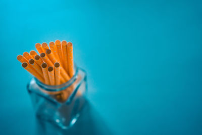 High angle view of orange blue glass on white background