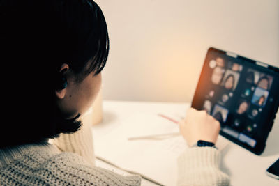 Close-up portrait of woman using laptop on table