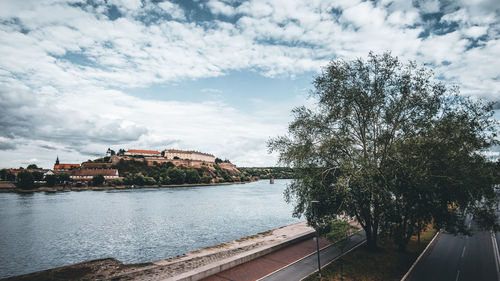 River amidst trees and buildings against sky