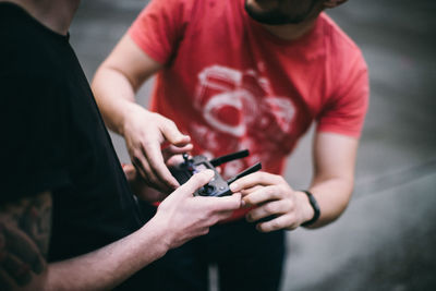 Midsection of man holding camera