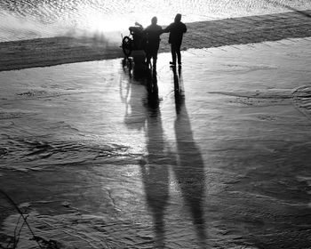 People on shore against sky