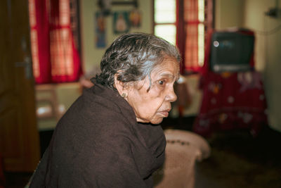 Side view of senior woman at home