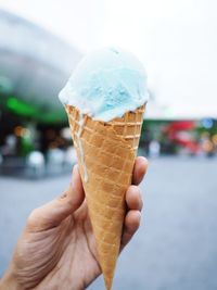 Cropped image of hand holding ice cream