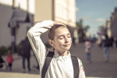 Close-up of girl against sky