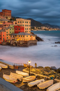 High angle view of buildings by sea against sky