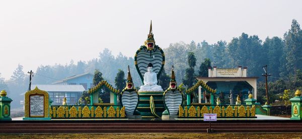 Panoramic view of a buddhist temple with trees in background 