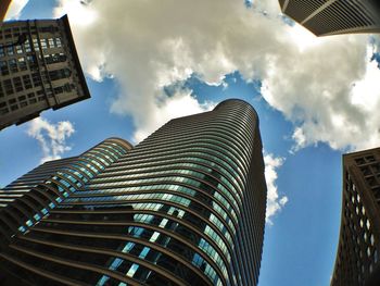 Low angle view of modern building against cloudy sky