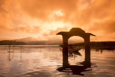 Reflection of clouds in lake at sunset