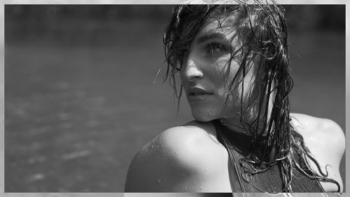 Close-up of young woman with water drop