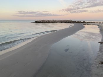 Scenic view of beach against sky during sunset