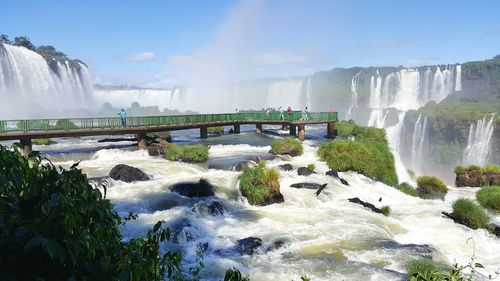 Scenic view of waterfall against sky