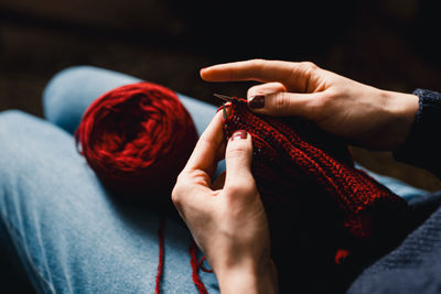 Cropped hands of woman holding wedding dress