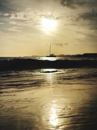 Sailboat on sea against sky during sunset