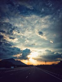 Road against dramatic sky during sunset