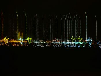 Illuminated lights against sky at night