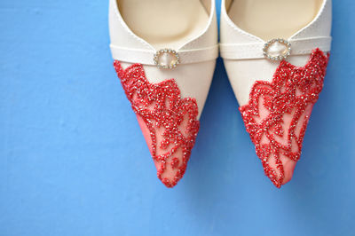 Close-up of designed shoes on blue table