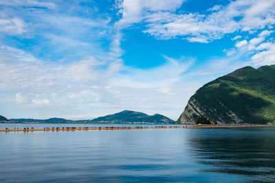 Scenic view of lake iseo against blue sky