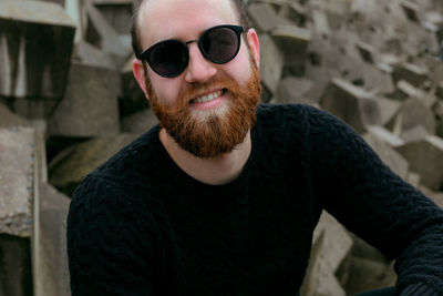 Portrait of young man wearing sunglasses standing outdoors