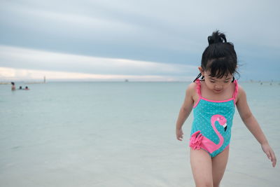 Full length of woman on beach against sky