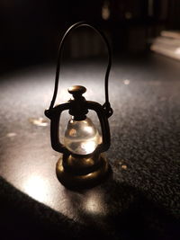 Close-up of illuminated lamp on table