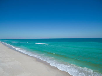 Scenic view of sea against clear blue sky